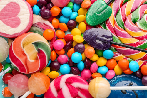 Sweet lollipops and candies as background, closeup photo