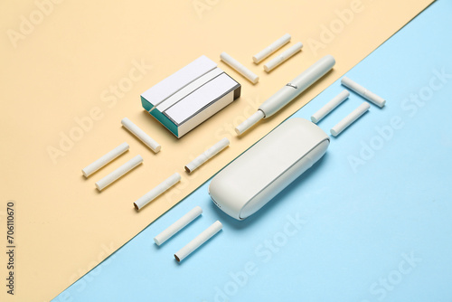 Composition with modern electronic cigar and sticks on colorful background