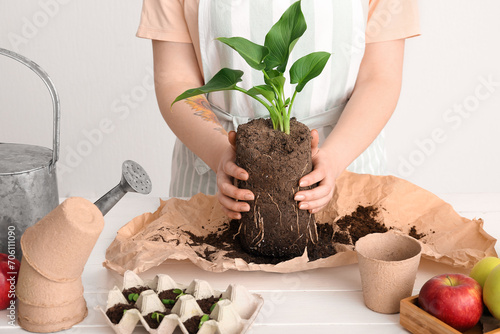 Woman holding soil with gre...