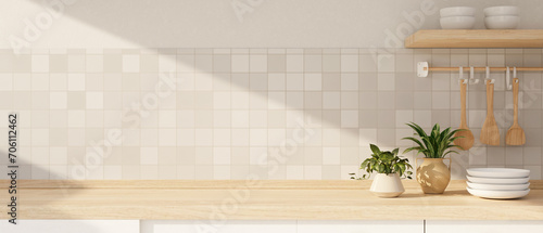Copy space for displaying your product on a wooden kitchen countertop against the white tiles wall. © bongkarn