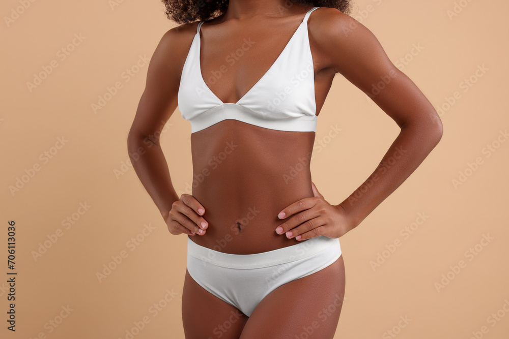 Woman in stylish bikini on beige background, closeup