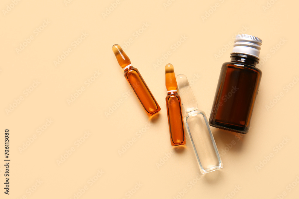 Ampules and bottle with medicines on beige background Ampules and bottle with medicines on beige background
