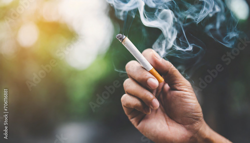Close-up of hand crushing a burning cigarette, symbolizing determination to quit smoking photo
