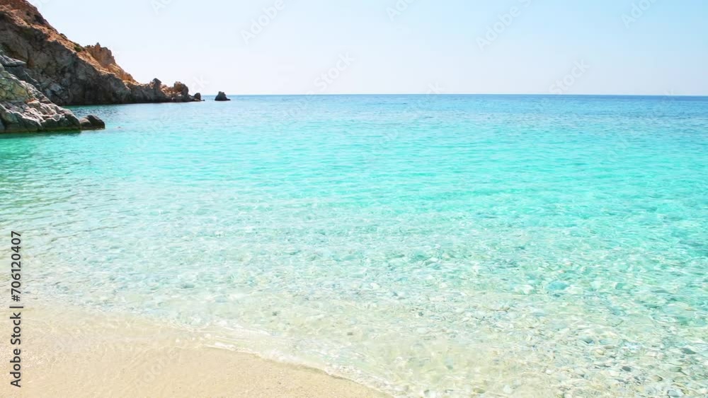 Seychelles beach, Ikaria island Greece by Magganitis village, Icarian sea with crystal clear turquoise water, rocky cliffs coast panning shot Seychelles beach, Ikaria island Greece by Magganitis village, Icarian sea with crystal clear turquoise water, rocky cliffs coast panning shot