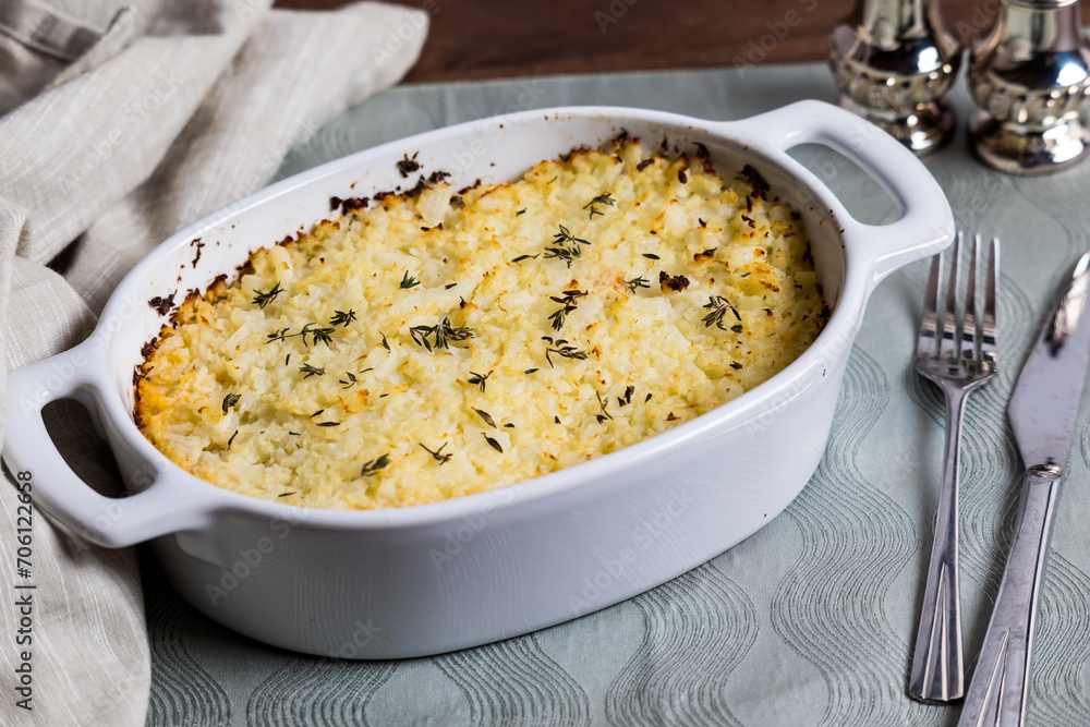 A casserole dish of homemade shepherd's pie topped with mashed cauliflower. A casserole dish of homemade shepherd's pie topped with mashed cauliflower.