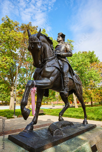 Bronze Equestrian Statue with Pink Ribbon in Park Setting