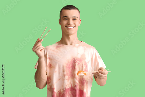 Young man with tasty sushi ...