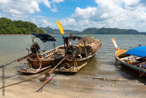 Fishing boats in the fishing village of Ban Ko Jum on the island of Ko Jum. A long-tail boat is loaded with fish and lobster traps. artisanal fishing is an important factor of local economy photo