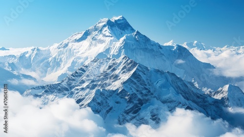 Snow-capped mountains above the clouds, clear blue sky