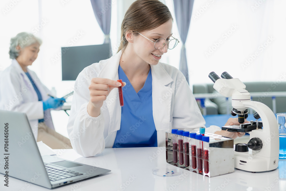 Portrait of a beautiful young female doctor sitting at a table Work in a medical clinic, in a resident's office at a computer Portrait of a beautiful young female doctor sitting at a table Work in a medical clinic, in a resident's office at a computer