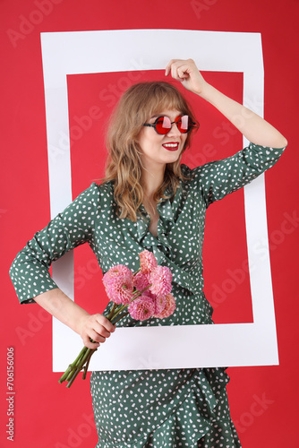 Young woman with flowers an...