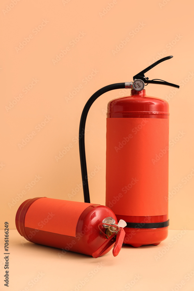 Naklejka premium Fire extinguishers on beige background