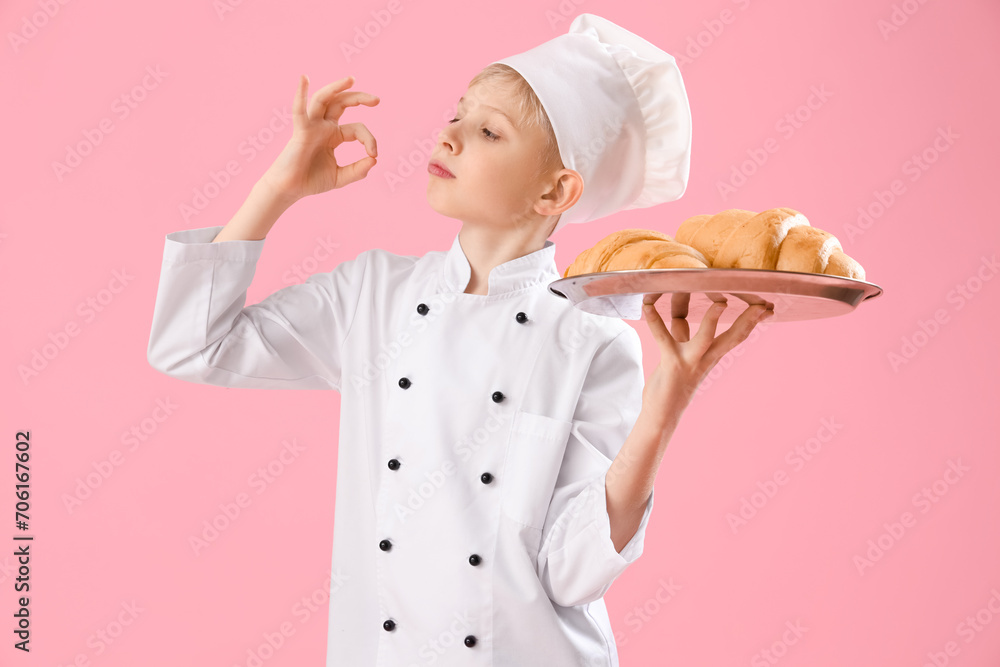 Cute little chef with croissants on pink background. Opposite Day celebration Cute little chef with croissants on pink background. Opposite Day celebration