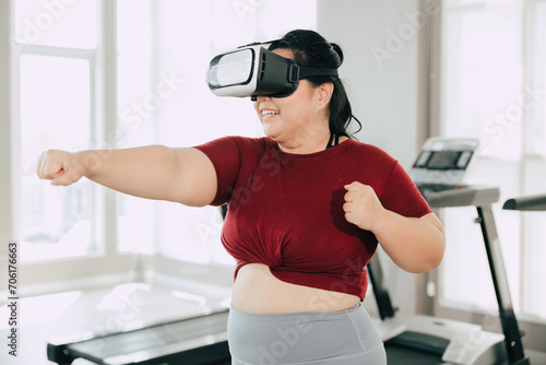 fat women with VR headset play visual reality sport game for exercise. people using modern technology for healtcare concept.