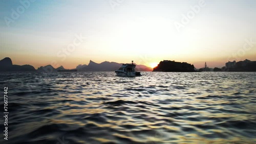 Scenic view of a yacht cruising the seas off the coast of Brazil at sunset photo