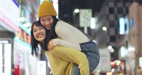 Wallpaper Mural Japanese women, piggyback and happiness in city for travel, bonding and leisure on weekend vacation. Friends, care and goofy play in tokyo town for holiday, wellness and relax together for social Torontodigital.ca