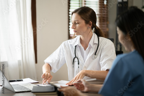 Wallpaper Mural Female doctor sitting at work looking at the history of patients in the clinic or in the hospital Torontodigital.ca