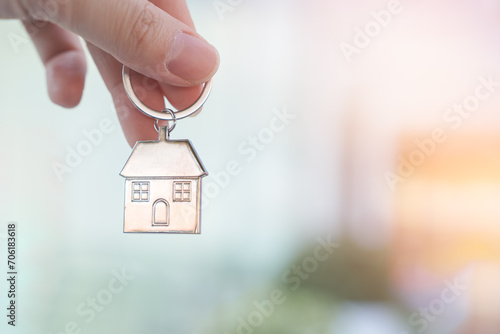 Hand holding house key. Decision to choose the best property with your right for a good start in life, Real estate financial and new housing loans concept.