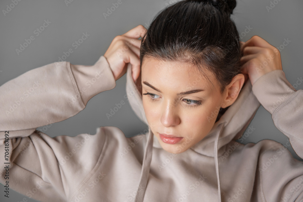 Pensive thoughtful young girl wearing sweatshirt with hood Pensive thoughtful young girl wearing sweatshirt with hood