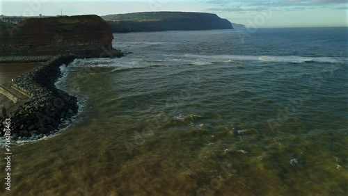 Drone Shot Flying Past Staithes up the Coast of Cliffs Towards Saltburn photo