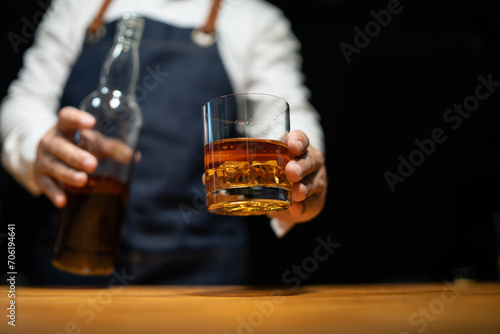 Barman pouring whiskey whiskey glass..