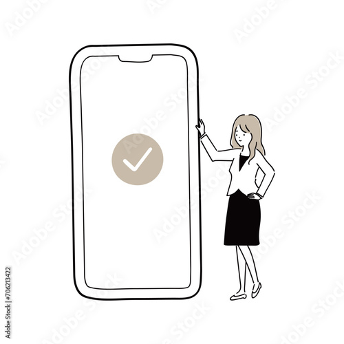 スマートフォンの画面に表示されたチェックマークを確認するビジネスウーマン