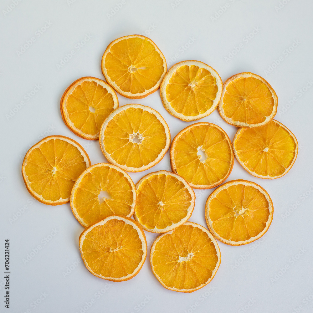 Delicious dry orange slices snack on white background, top view. content for a blog about healthy nutrition. Copy space Delicious dry orange slices snack on white background, top view. content for a blog about healthy nutrition. Copy space