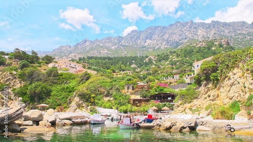 Magganitis fishing village harbor marina port, moored boats ships by coast shore cafe restaurant on Ikaria island, Greece Greek longevity blue zone photo