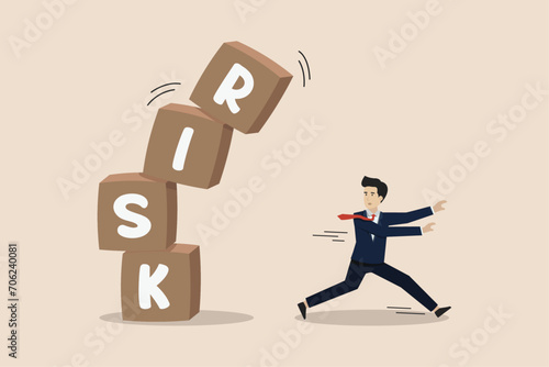 Risk averse, run away from uncertainty, fear or safety decision for investment, businessman investor run away from risk collapsing box. photo