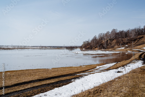 Spring in nature  flooding on the river  flooded crop fields  snow melting  the river overflowing its banks  natural disaster.