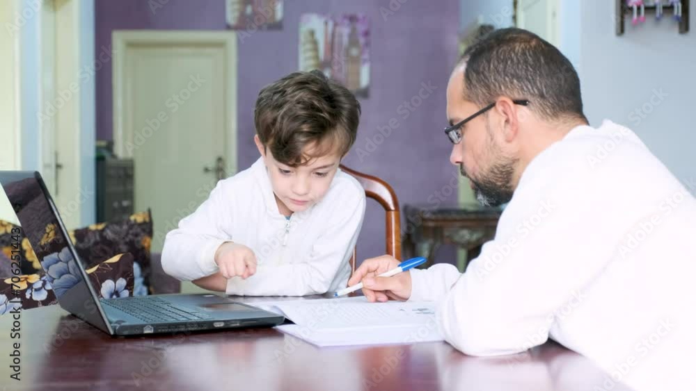 Arabic man teaching his kid in home during quarantine and supporting his kid learning Arabic man teaching his kid in home during quarantine and supporting his kid learning