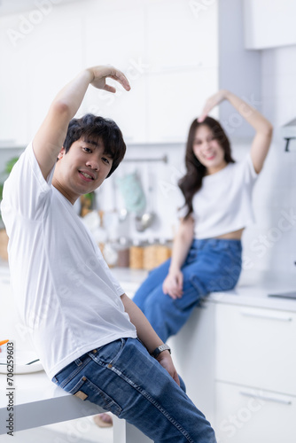 Happy portrait of cheerful young loving couple asian of having fun heart-shaped hand gesture standing a cheerful preparing food and enjoy cook cooking while standing on a kitchen Condo life or home