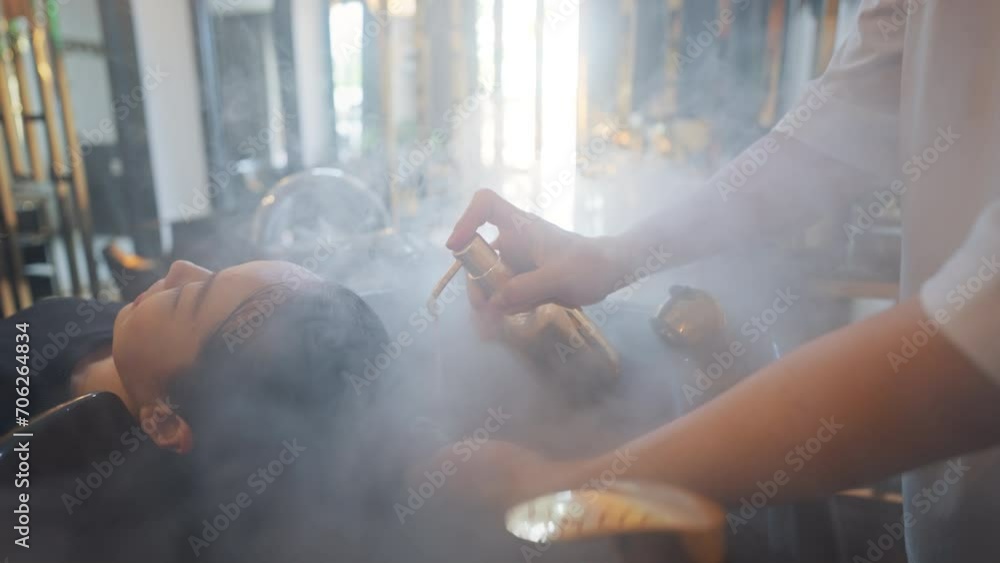 Professional stylist worker or hairdresser is washing customer hair with shampoo and water at professional sink in beauty salon or barber shop. Hair care concept. Professional stylist worker or hairdresser is washing customer hair with shampoo and water at professional sink in beauty salon or barber shop. Hair care concept.