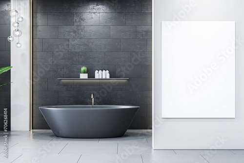 Modern bathroom with black tile wall  freestanding tub  and framed poster mockup. 3D Rendering