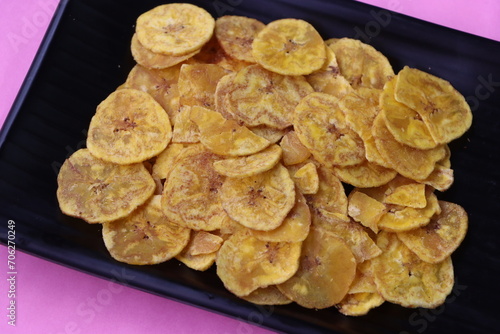 Banana chips on a black background, banana chips for Onam festival, traditional South Indian tea time snack