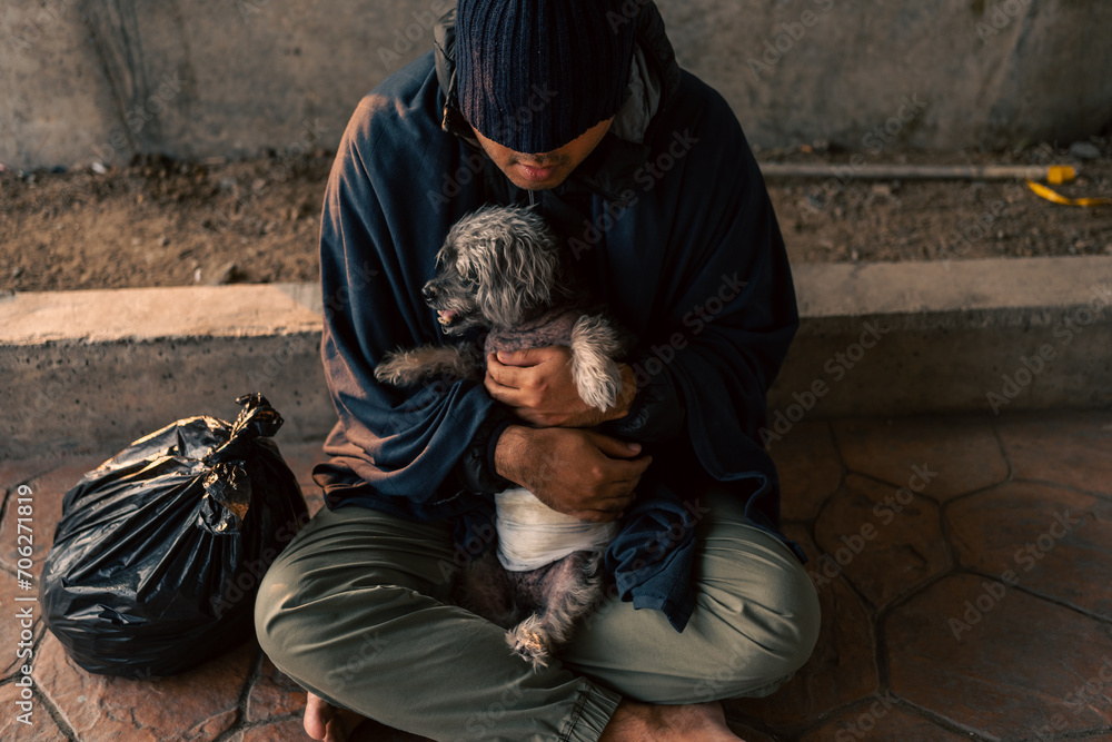 Homeless man and dog on the street waiting for help food and money from people volunteer foundation donate. Poor tired stressed depressed hungry homeless man