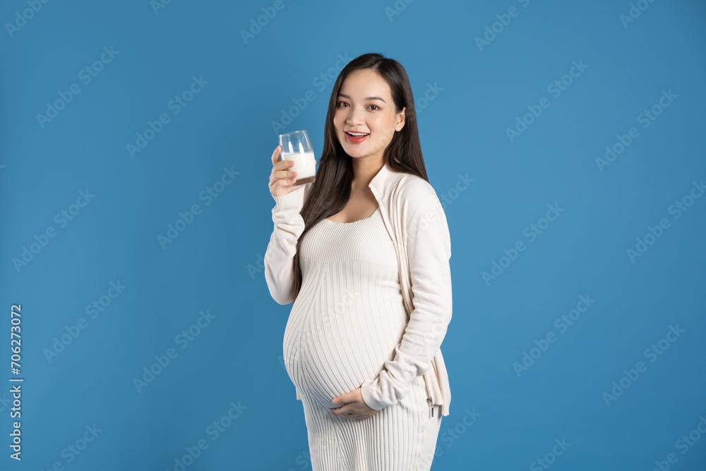 Portrait of pregnant asian woman, isolated on blue background Portrait of pregnant asian woman, isolated on blue background