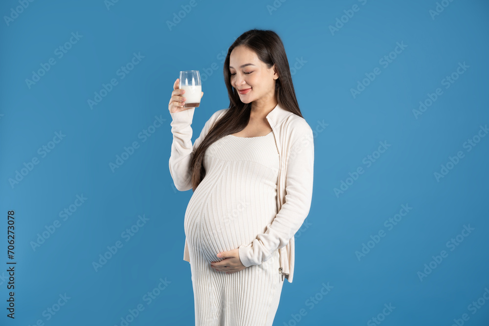 Portrait of pregnant asian woman, isolated on blue background Portrait of pregnant asian woman, isolated on blue background