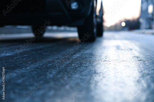 Icy road. Close up photo with the asphalt covered with ice after a freezing rain in the winter morning. Danger for driving. photo