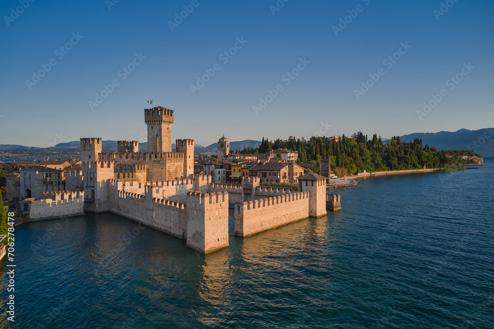 Scaliger Castle in Sirmione on Lake Garda Italy, aerial view at sunrise.