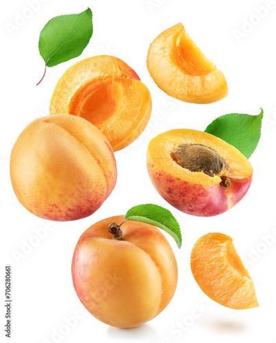 Ripe apricot and apricot halves levitating in air on white background. Clipping paths.