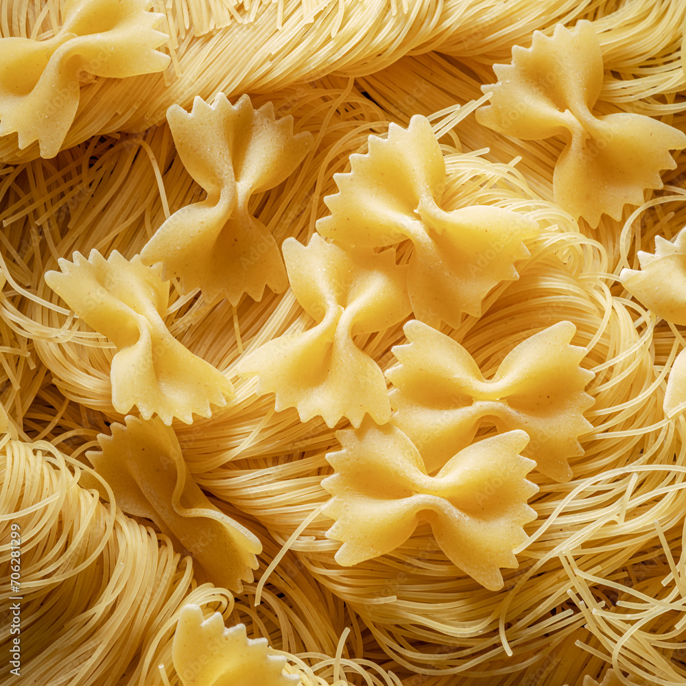 Italian pasta farfalle and vermicelli close-up. Food background.