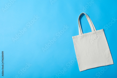A white bag lies on a blue background