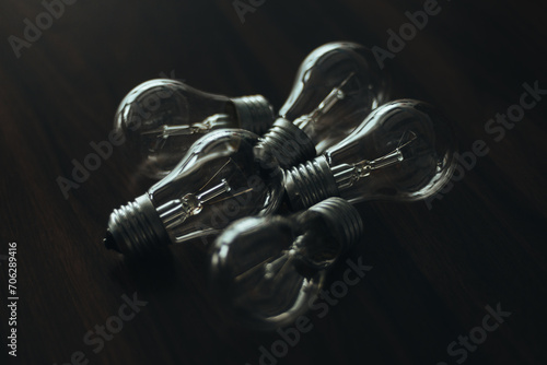 Light bulbs on the table. Wooden table. Background image. Lots of non-working light bulbs. No light. Selective Focus