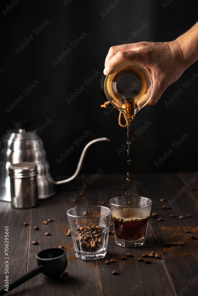 Process of hand pouring coffee into a cup