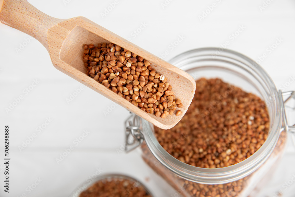 Raw buckwheat in a bowl on a textured wooden background. Wheat grains, porridge, cereals, raw buckwheat in a plate. Healthy food. Porridge. Diet. Organic cerea. Space for text.Copy space. Raw buckwheat in a bowl on a textured wooden background. Wheat grains, porridge, cereals, raw buckwheat in a plate. Healthy food. Porridge. Diet. Organic cerea. Space for text.Copy space.