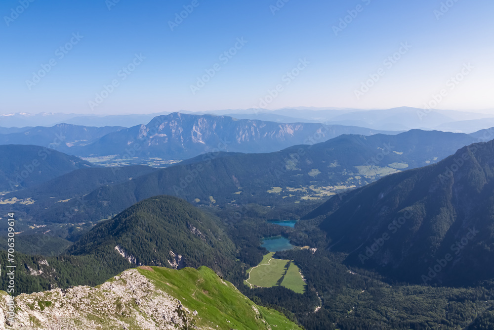 Aerial view of alpine lakes Laghi di Fusine in Tarvisio, Friuli-Venezia Giulia, Italy, Europe. View of mountain peak Dobratsch, Gailtal Alps, Carinhtia, Austria. Hiking trail to Mangart, Julian Alps