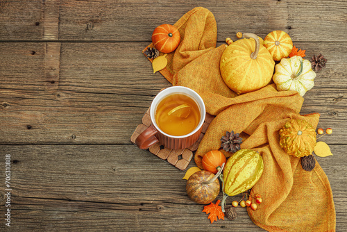 Spicy hot tea. Autumn good mood, traditional fall beverage. Pumpkin, scarf, leaves, pine cones