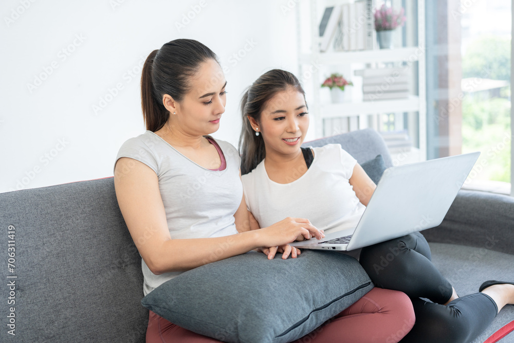 Two young beautiful asian woman relaxing after work out. Cheerfully sporty female workout and exercise wearing sport wear at home. Two young beautiful asian woman relaxing after work out. Cheerfully sporty female workout and exercise wearing sport wear at home.