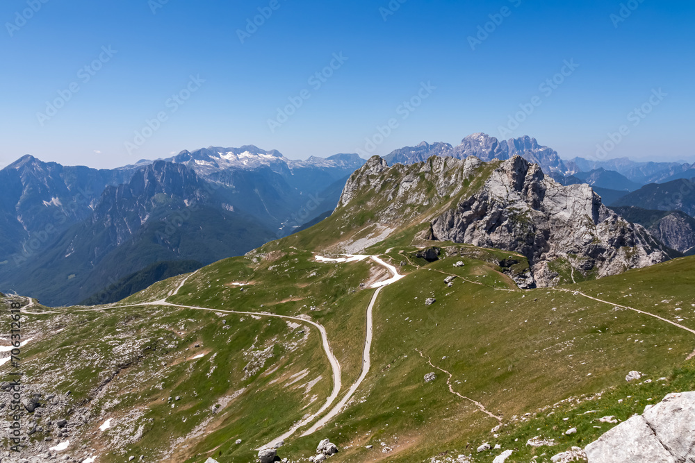 Scenic view of high alpine Mangart road (Mangartska cesta) seen from Mangart Saddle (Mangartsko sedlo) in untamed Julian Alps, border Slovenia Italy, Europe. Hiking wanderlust in Friuli Venezia Giulia